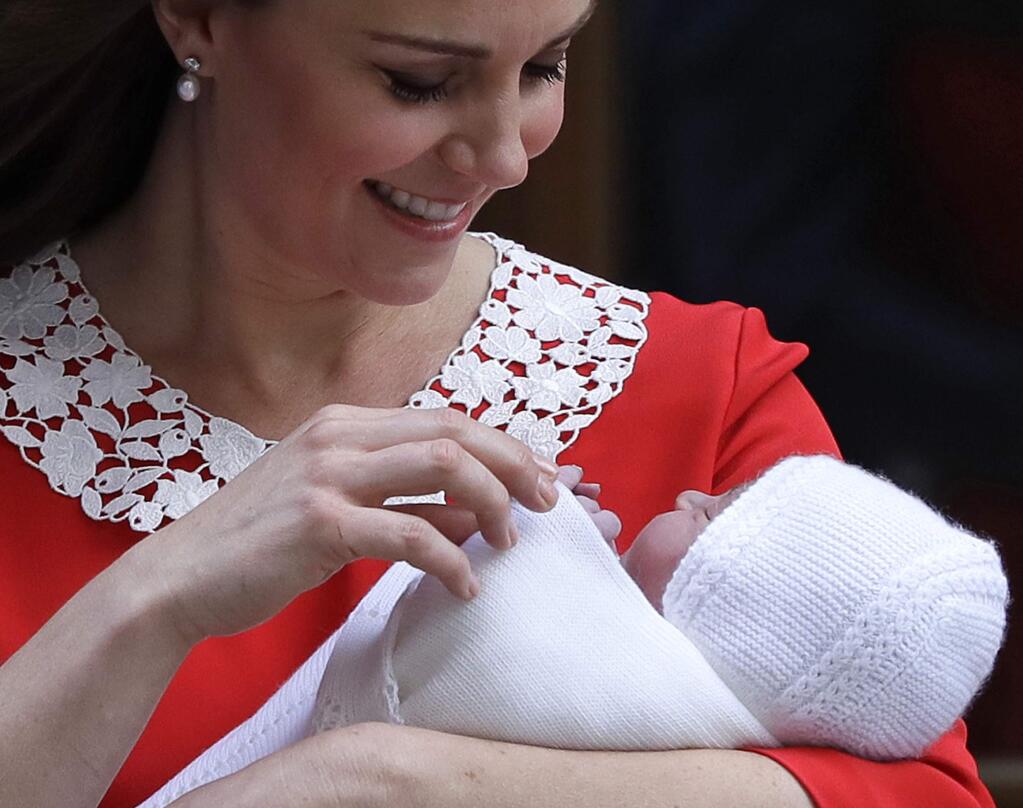 FILE - In this file photo dated Monday, April 23, 2018 Kate, Duchess of Cambridge holds her newborn baby son, to be named Prince Louis, as she leaves the Lindo wing at St Mary's Hospital in London London. The Christening of Prince Louis, third child of the Duke and Duchess of Cambridge, will take place Monday July 9, 2018, at Chapel Royal in St. James's Palace, London. (AP Photo/Kirsty Wigglesworth, FILE)