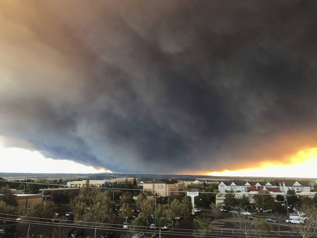 The massive plume from the Camp Fire, burning in the Feather River Canyon near Paradise, Calif., wafts over the Sacramento Valley as seen from Chico, Calif., on Thursday, Nov. 8, 2018. Authorities in Northern California have ordered mandatory evacuations in a rural area where the wildfire has grown to 1,000 acres (405 hectares) amid hot and windy weather. (David Little/Chico Enterprise-Record via AP)