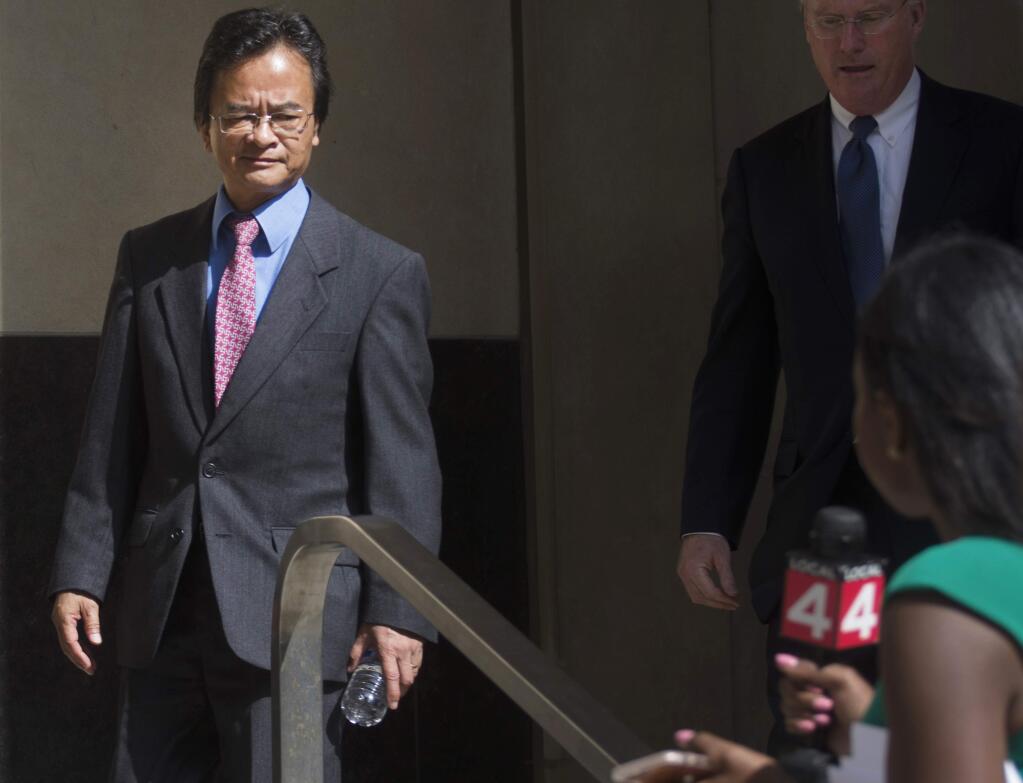FILE - In this Sept. 9, 2016, file photo, Volkswagen engineer James Robert Liang, left, leaves court, in Detroit, after pleading guilty to one count of conspiracy in the company's emissions cheating scandal. U.S. prosecutors are seeking a three-year prison sentence for a Volkswagen engineer who had a key role in the company's diesel emissions scandal. Liang is scheduled to be sentenced Friday, Aug. 25, 2017, in Detroit federal court. He is one of two VW employees to plead guilty, although others charged in the case are in Germany and out of reach. (Virginia Lozano/Detroit News via AP, File)