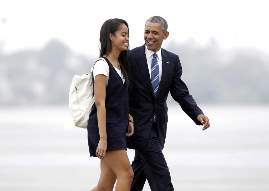 FILE- In this April 8, 2016, file photo, President Barack Obama and his daughter Malia walk from Marine One toward Air Force One at Los Angeles International Airport. Malia is taking a year off after graduating from high school before attending Harvard University as part of an expanding program for students known as a 'gap year.' (AP Photo/Nick Ut, File)