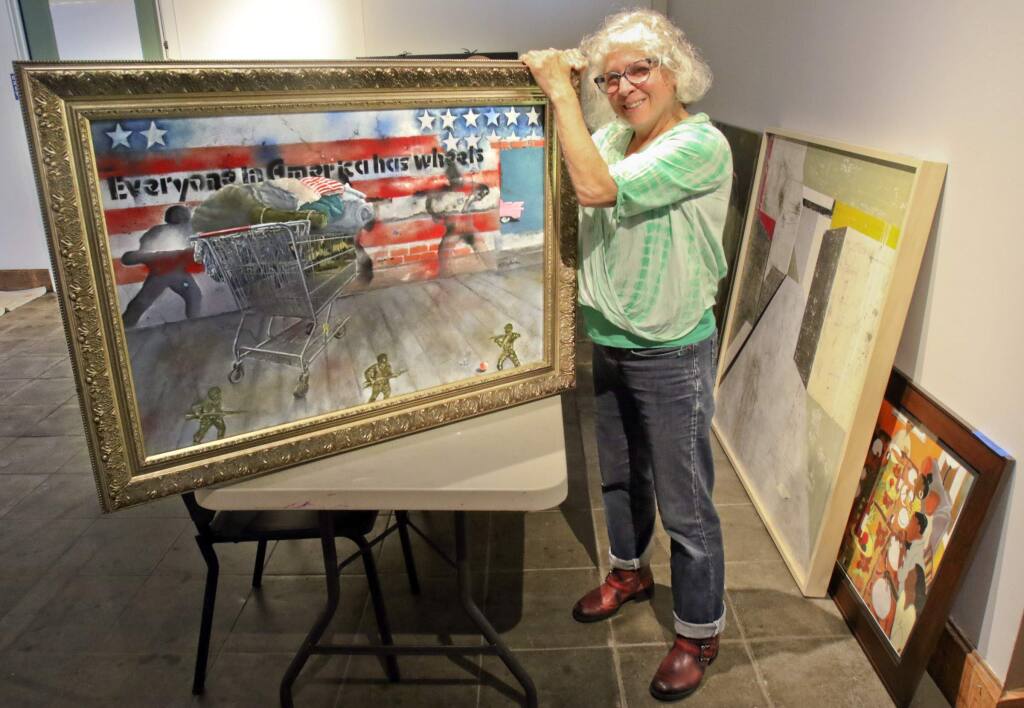 Evelyn Nitzberg of Petaluma delivers her painting 'Everyone in America has Wheels' to the Petaluma Art Center to be part of the Zeitgeist show on Wednesday, May 4, 2016. (SCOTT MANCHESTER/ARGUS-COURIER STAFF)