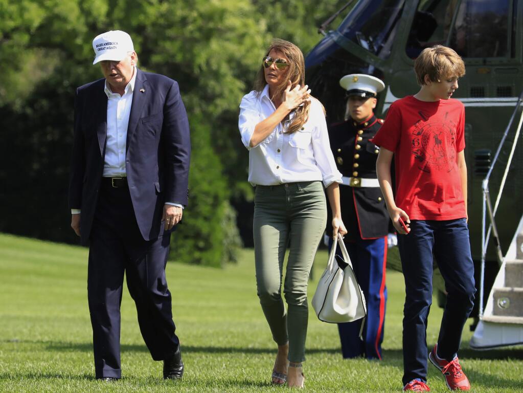 President Donald Trump, first lady Melania Trump and their son Barron Trump walk on the South Lawn upon arrival at the White House in Washington, Sunday, June 18, 2017, from Camp David in Maryland. (AP Photo/Manuel Balce Ceneta)