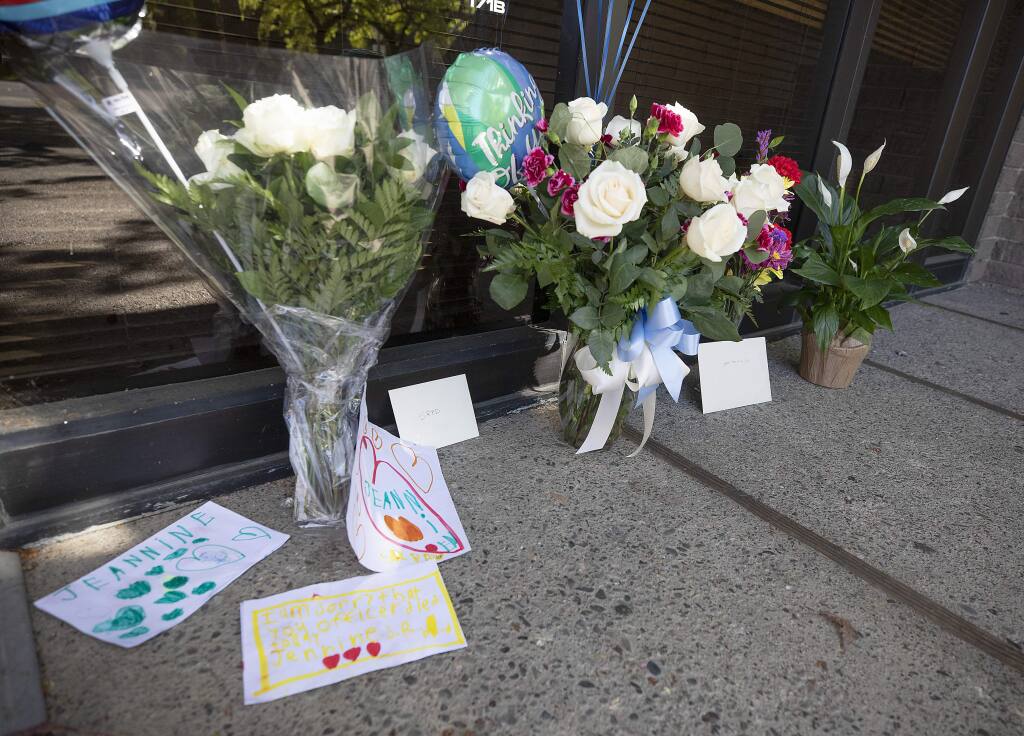 A memorial of flowers and notes fat the Santa Rosa Police office for Detective Mary Lou Armer, who died Tuesday of complications caused by the coronavirus. (photo by John Burgess/The Press Democrat)