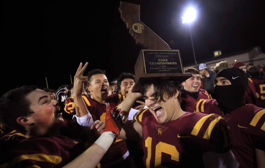 Ethan Kollenborn and the rest of his Cardinal Newman teammates celebrate their Division 3-AA state championship victory over the El Camino High School Wildcats of Oceanside, Saturday, Dec.14, 2019 in Santa Rosa. (Kent Porter / The Press Democrat)