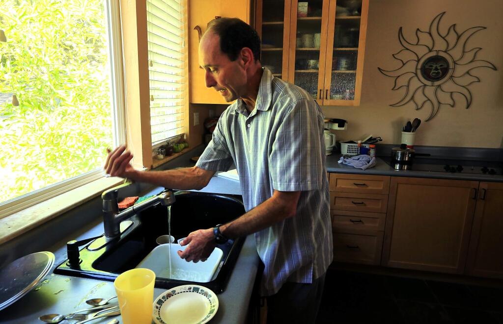 Russian Riverkeeper Don McEnhill likes a single lever water faucets so he can use an arm or back of the hand to turn the water off and on as he uses soap at his Healdsburg home. (JOHN BURGESS / The Press Democrat)