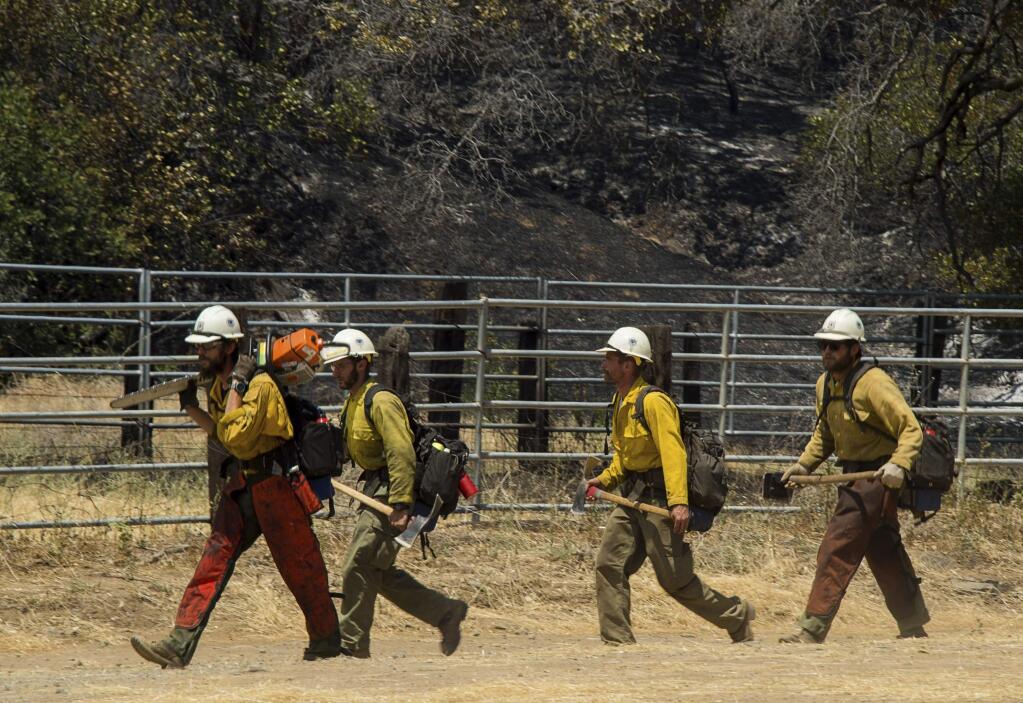 Fire crews deploy to fight a wildfire burns in Yolo County, Calif., Sunday, July 1, 2018. Smoke from the Yolo County fire was contributing to poor air quality in Napa, Sonoma, San Mateo and San Francisco counties, according to the National Weather Service. (Paul Kitagaki Jr./The Sacramento Bee via AP)