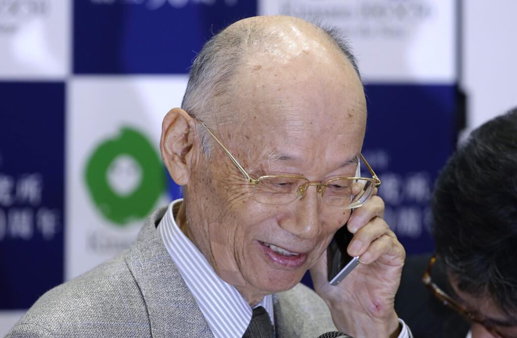 Kitasato University Prof. Emeritus Satoshi Omura talks with Japanese Prime Minister Shinzo Abe on the phone during a press conference at the university in Tokyo, Monday, Oct. 5, 2015 after learning he and two other scientists from Ireland and China won the Nobel Prize in medicine. The Nobel judges in Stockholm awarded the prestigious prize to Omura, Irish-born William Campbell and Tu Youyou - the first-ever Chinese medicine laureate, for discovering drugs against malaria and other parasitic diseases that affect hundreds of millions of people every year. (AP Photo/Shizuo Kambayashi)