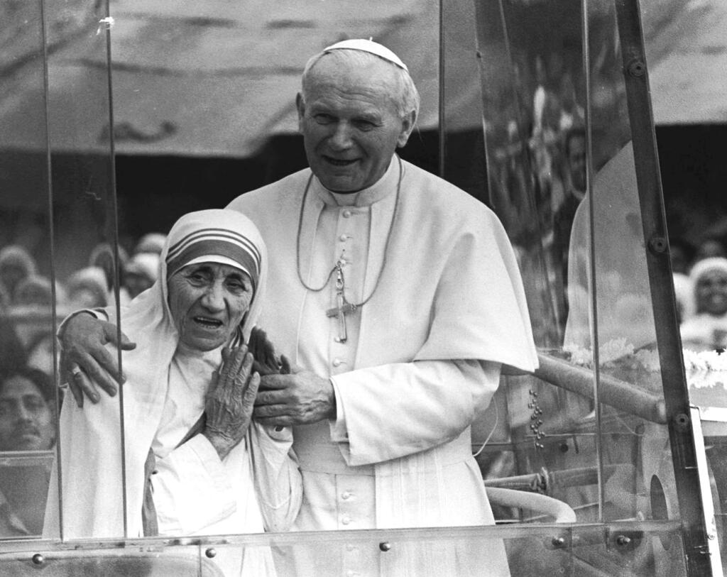 In this 1986 file photo, Pope John Paul II holds his arm around Mother Teresa in Kolkata, India. (AP Photo)