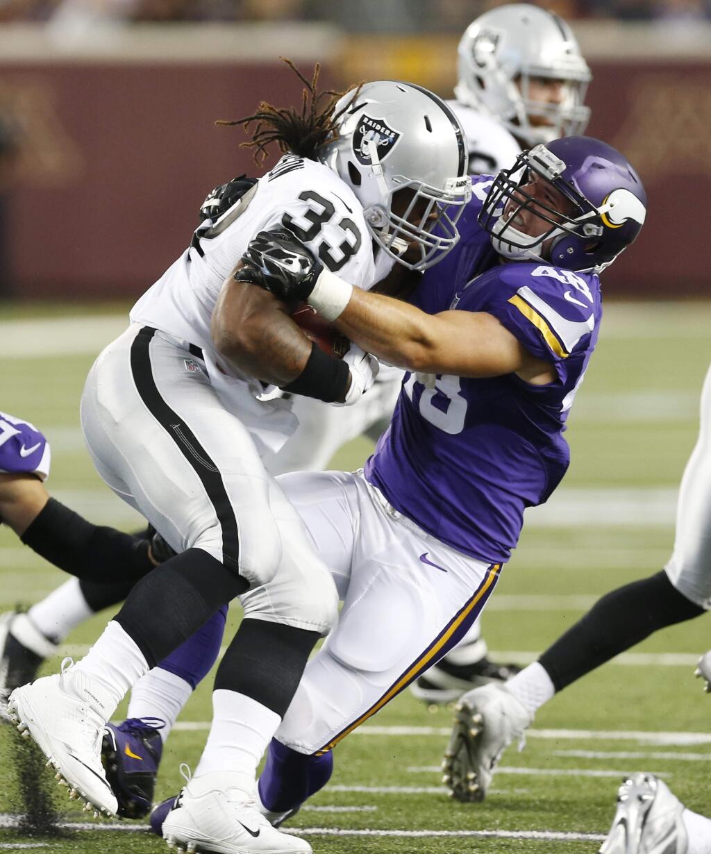 Oakland Raiders running back Trent Richardson (33) is stopped by Minnesota Vikings fullback Zach Line during the first half of a preseason NFL football game, Saturday, Aug. 22, 2015, in Minneapolis. (AP Photo/Jim Mone)