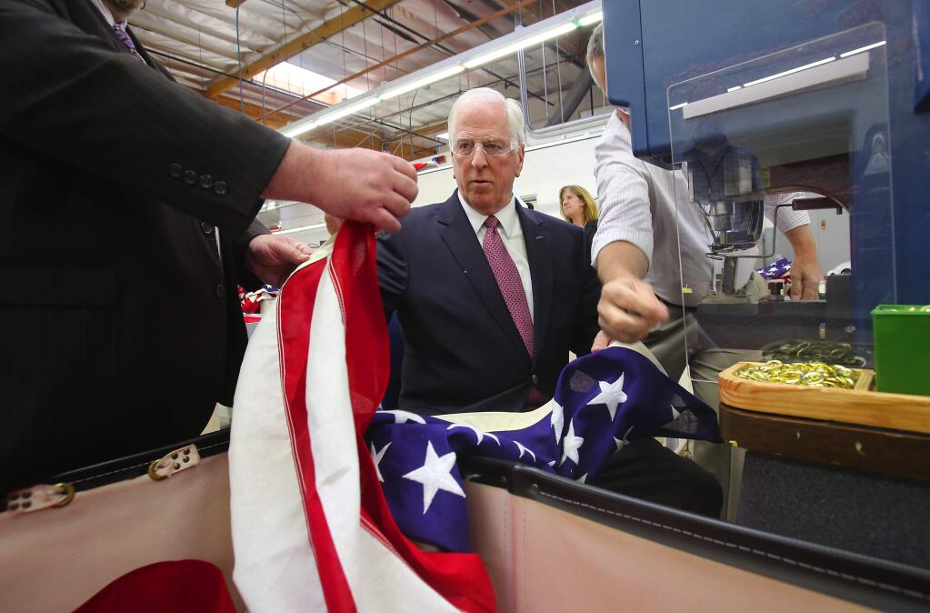 Rep. Mike Thompson is shown how to put grommets onto an American flag during a tour of North Bay Industries in Rohnert Park on Tuesday, Feb. 18, 2014. (John Burgess/The Press Democrat)