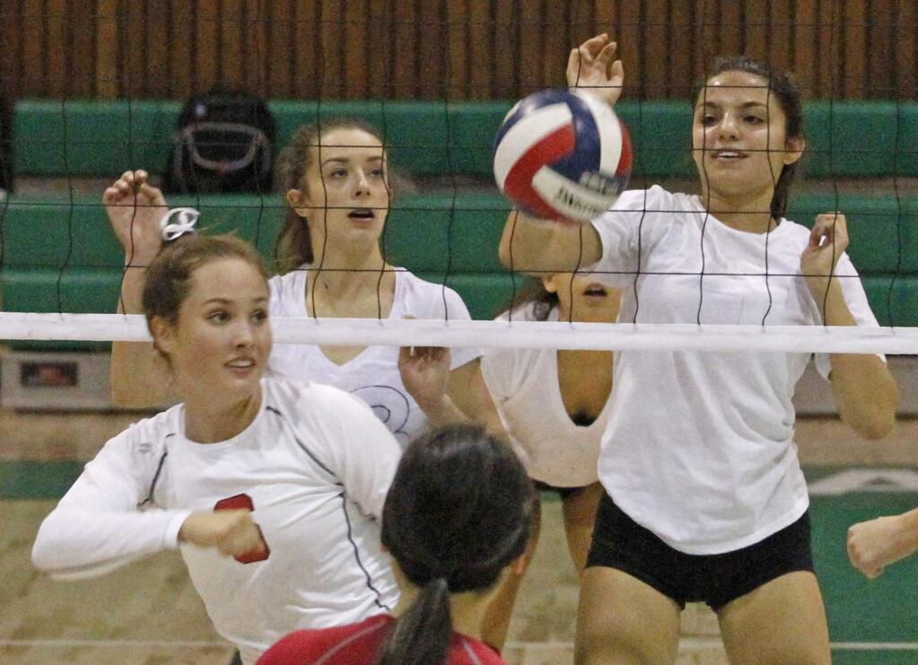 Bill Hoban/Index-TribuneLady Dragons Gigi Girish, left, and Raegan Cordero, right, watch as a ball falls to the floor on the Montgomery side of the net during a recent match. The undefeated Lady Dragon will host Piner today, Tuesday, Sept. 6.