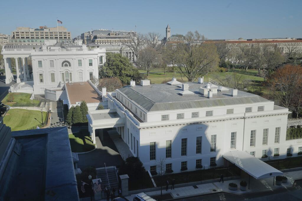 In this photo taken March 29, 2017, the main residence of the White House in Washington and the West Wing, right, as seen, Wednesday from the Eisenhower Executive Office Building on the White House complex in Washington. A top White House communications staffer has resigned as President Donald Trump considers overhauling his White House staff over frustrations that his team is struggling to contain the burgeoning crisis involving alleged Russian meddling in the 2016 election. (AP Photo/Pablo Martinez Monsivais, File)