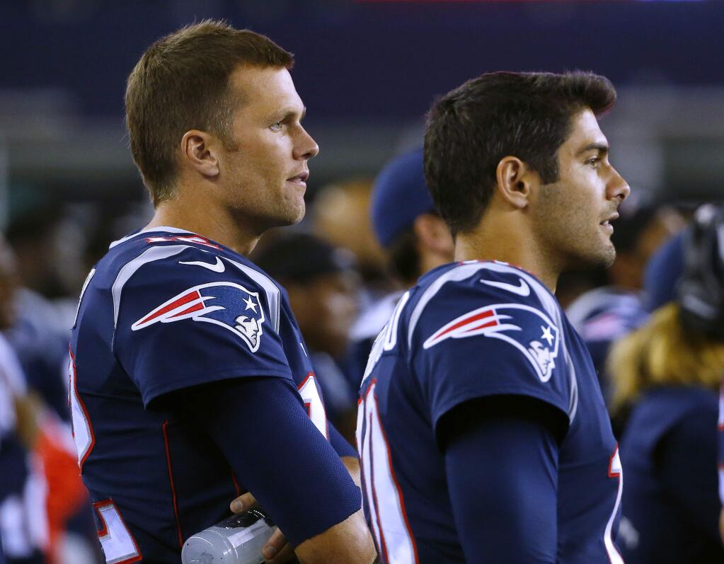 In this Thursday, Aug. 31, 2017 file photo, New England Patriots quarterback Tom Brady, left, and quarterback Jimmy Garoppolo wach from the sideline during the second half of a preseason game against the New York Giants in Foxborough, Mass. On Monday, Oct. 30, 2017, the Patriots traded Garoppolo to the San Francisco 49ers for a 2018 draft pick. (AP Photo/Winslow Townson, File)