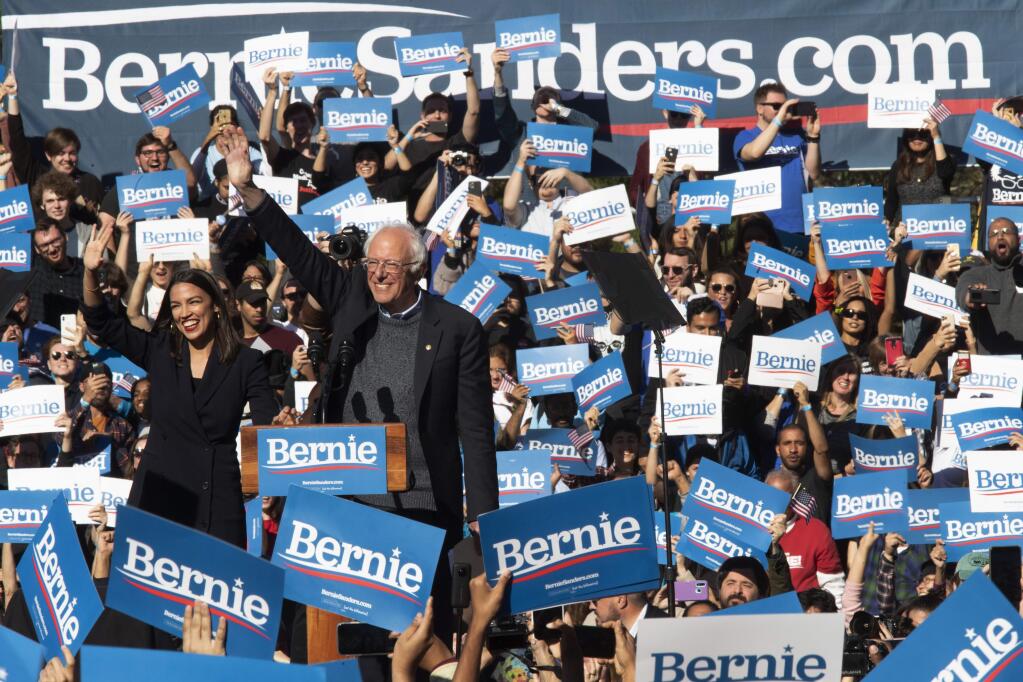 Democratic presidential candidate Sen. Bernie Sanders, I-Vt., right, is introduced by Rep. Alexandria Ocasio-Cortez, D-N.Y., during a campaign rally, Saturday, Oct. 19, 2019, in the Queens borough of New York. (AP Photo/Mary Altaffer)