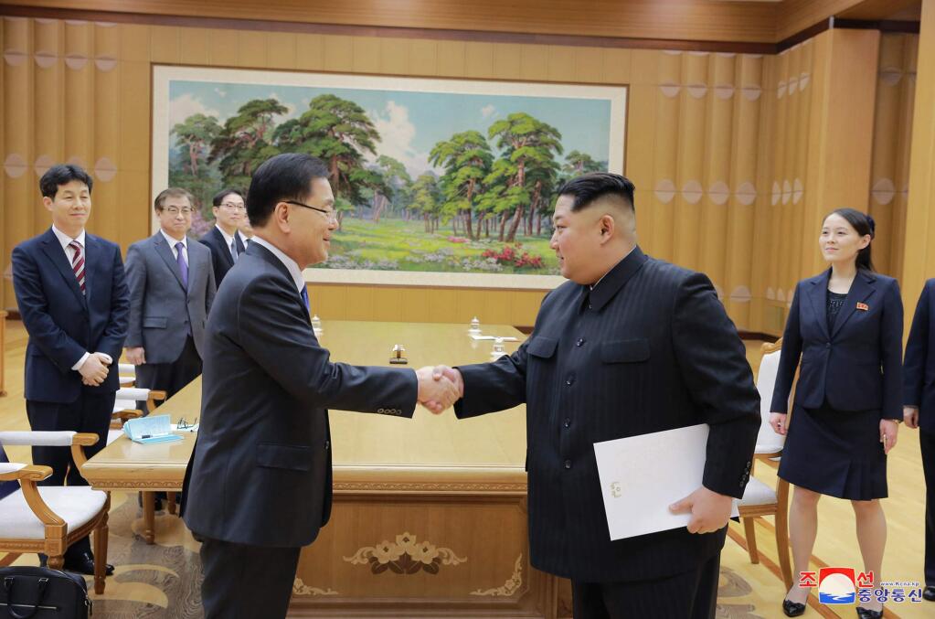 In this Monday, March 5, 2018 photo, provided by the North Korean government on March 6, North Korean leader Kim Jong Un, front right, shakes hands with South Korean National Security Director Chung Eui-yong after Chung gave Kim the letter from South Korean President Moon Jae-in, in Pyongyang, North Korea. Independent journalists were not given access to cover the event depicted in this image distributed by the North Korean government. The content of this image is as provided and cannot be independently verified. Korean language watermark on image as provided by source reads: 'KCNA' which is the abbreviation for Korean Central News Agency. (Korean Central News Agency/Korea News Service via AP)