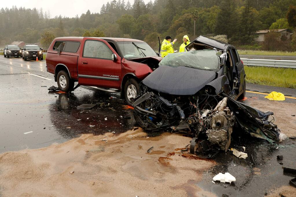 California Highway Patrol officers Mike Ball, left, and Crandon Kopriva investigate the scene of a fatal accident on northbound Highway 101, past the Geyserville Avenue exit in Geyserville, California, on Friday, March 22, 2019. (Alvin Jornada / The Press Democrat)