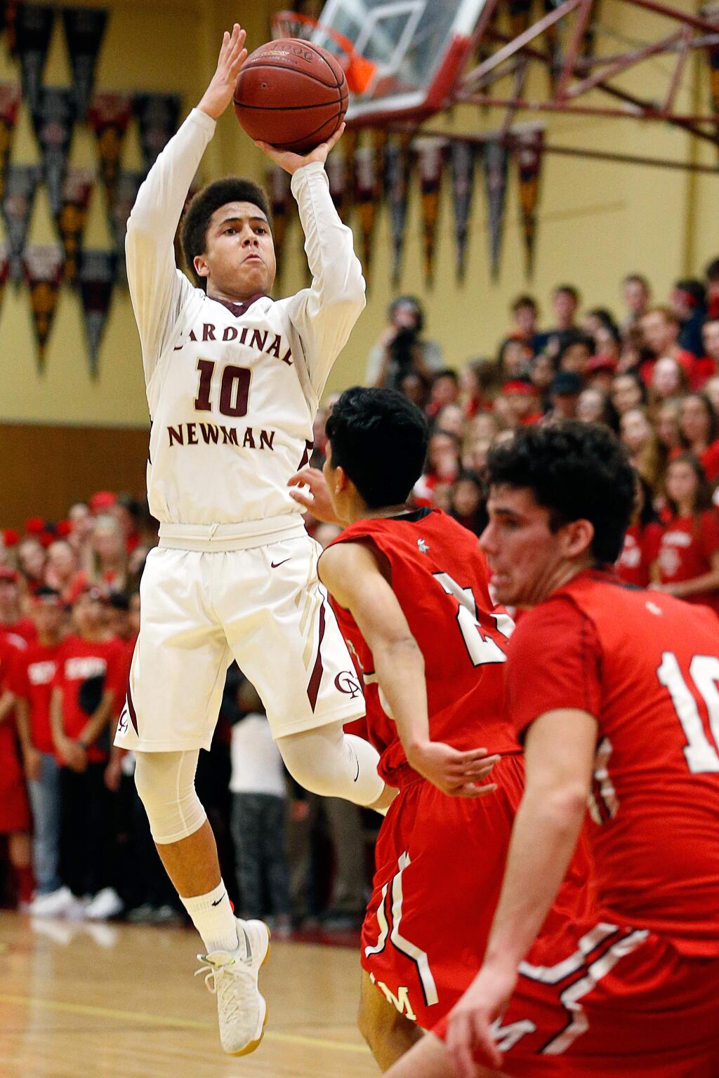 Cardinal Newman's Damian Wallace (10), left, puts up a shot while defended by Montgomery's Alex Soria (21) during the second half on Friday, Jan. 13, 2017. (Alvin Jornada / The Press Democrat)