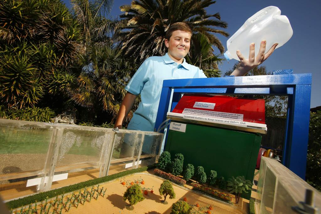 Steven McDowell, 15, demonstrates how his water fence collects rain water and stores water at his home in Rohnert Park on Wednesday, September 3, 2014. The Tech High student has received interest in the idea and will be unveiling it next month at the Greenbuild Expo in New Orleans. (Conner Jay/The Press Democrat)