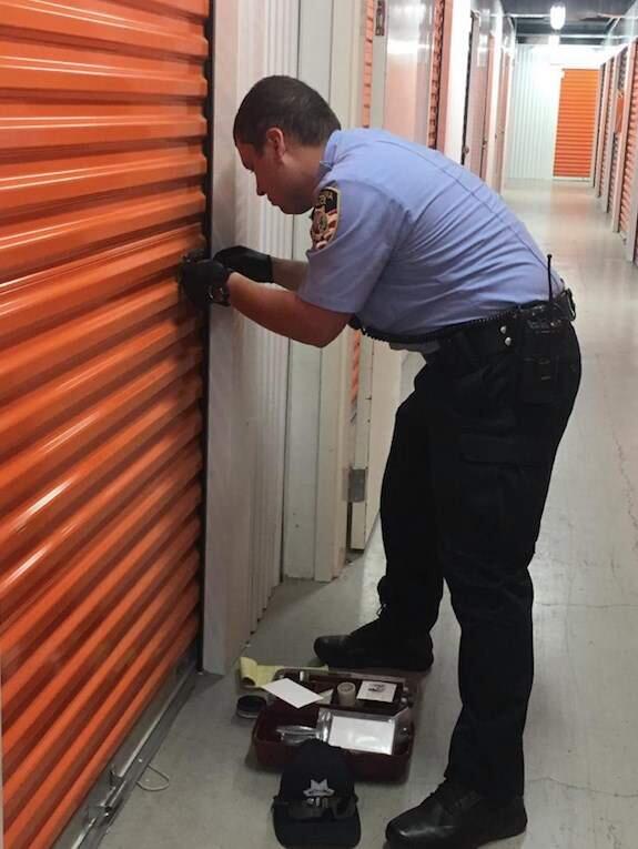A civilian employee of the Petaluma Police Department inspects Kristina and Christian Fogliani's locker at Public Storage on the 900 block of Transport Way. The Foglianis say up to $100,000 of artwork was stolen from their storage unit.