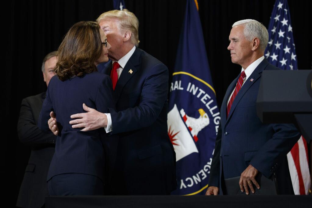 Secretary of State Mike Pompeo, left, and Vice President Mike Pence, right, look on as President Donald Trump congratulates incoming Central Intelligence Agency director Gina Haspel at CIA Headquarters, Monday, May 21, 2018, in Langley, Va. (AP Photo/Evan Vucci)