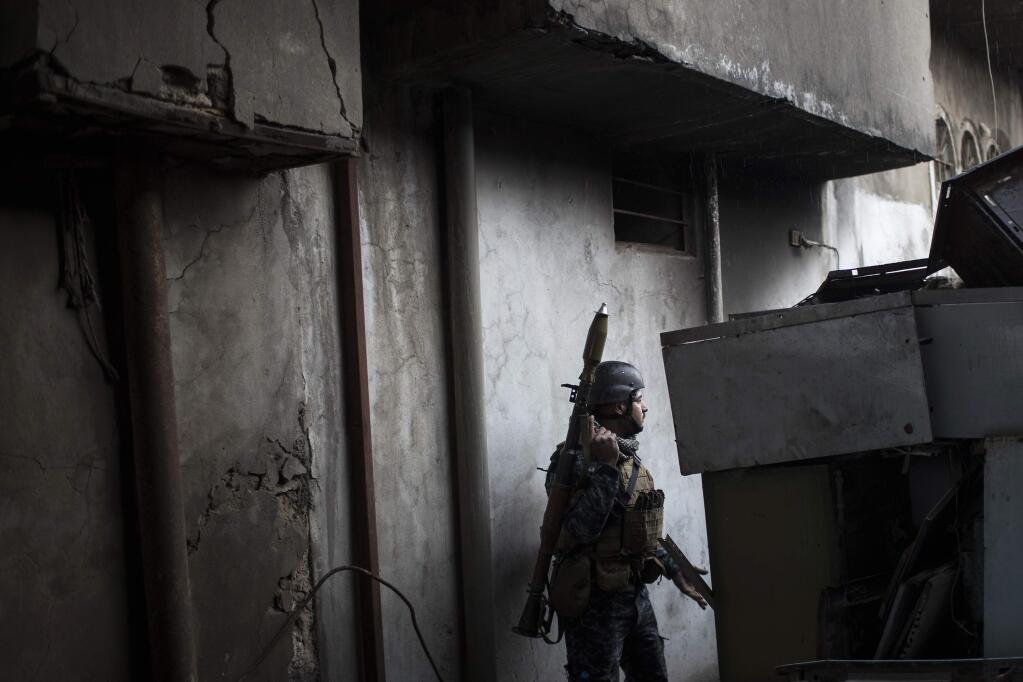 A Federal Police soldier moves towards the front line near the old city, during fighting against Islamic State militants on the western side of in Mosul, Iraq, Tuesday, March 28, 2017. (AP Photo/Felipe Dana)