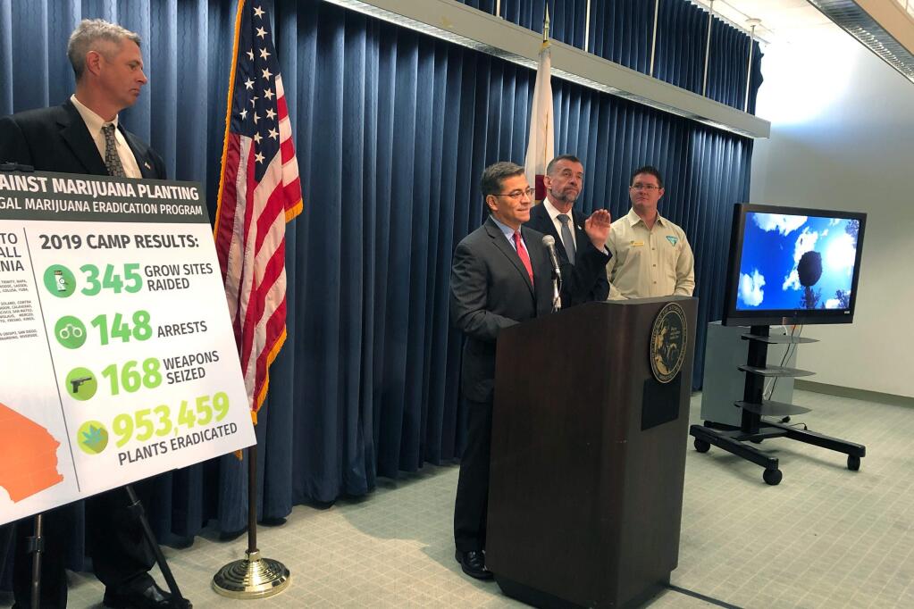 California Attorney General Xavier Becerra, at podium, discusses the results of an illegal marijuana eradication program during a press conference Monday, Nov. 4, 2019, in Los Angeles. The the results are part of an effort to target illegal cannabis grows on public lands statewide. (AP Photo/Stefanie Dazio)