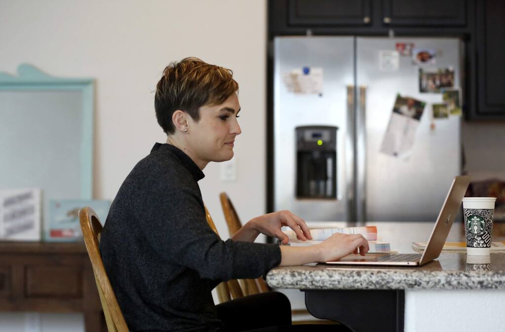 Sonoma State University nursing student Alexandra Holbrook does an online simulation to make up clinical hours required for her degree. Photo taken at her home in Rohnert Park on Tuesday, March 31, 2020. (BETH SCHLANKER/ The Press Democrat)