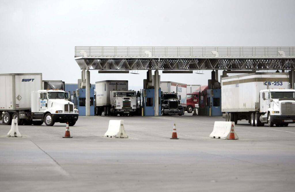 Trucks crossing into the United States from Mexico pour through a U.S. Custom's inspection station at the Otay Mesa Border Crossing in San Diego. (LENNY IGNELZI / Associated Press, 2004)