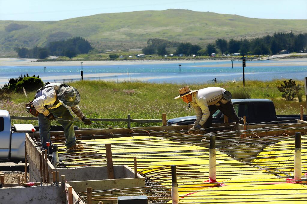 Workers place rebar for cement foundations for 70 homes in the Harbor View subdivision in Bodega Bay that has been stalled for three decades. (John Burgess/The Press Democrat)