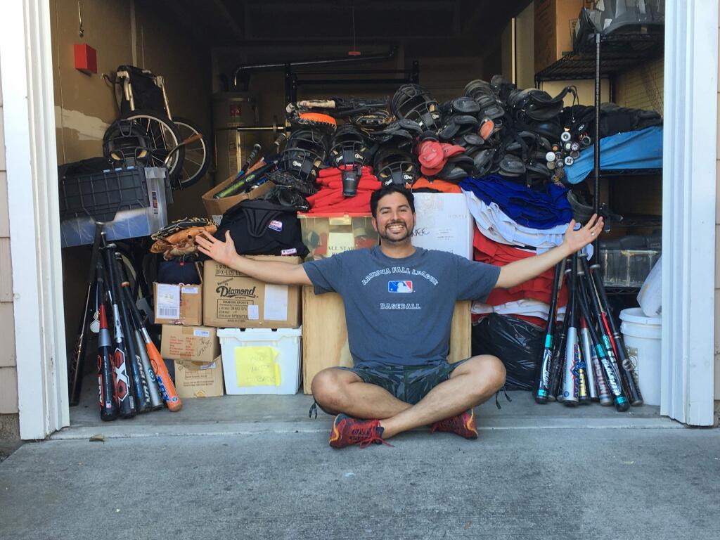 PHOTO COURTESY ISAIAS FRANCOIsaias Franco in front of the garage at his Petaluma home that is crammed with baseball equipment he will deliver to the Dominican Republic.