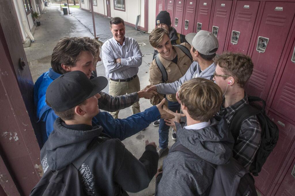 El Molino High School principal Matt Dunkle, center, jokes with a group of students during the lunch period in Forestville on Wednesday. The West Sonoma County Union High School District has changed their intradistrict transfer policies to comply with state codes. (photo by John Burgess/The Press Democrat)