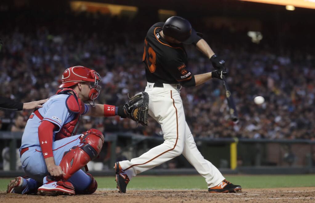 The San Francisco Giants' Austin Slater, right, hits a grand slam in front of St. Louis Cardinals catcher Matt Wieters during the fourth inning in San Francisco, Saturday, July 6, 2019. (AP Photo/Jeff Chiu)