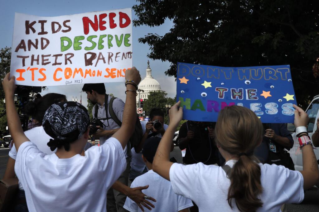 Families march past the U.S. Capitol as they protest the separation of immigrant families, Thursday, July 26, 2018, on Capitol Hill in Washington. (AP Photo/Jacquelyn Martin)