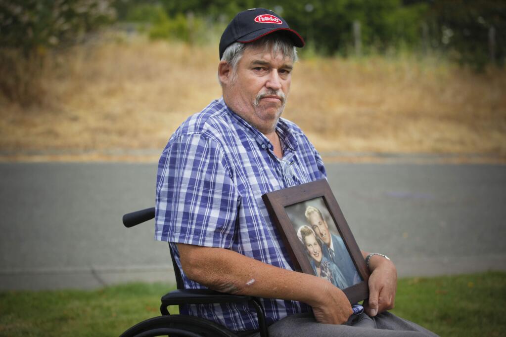 Doug Silva holds a wedding photo of his parents, Veana and Robert which he was reunited with when it was discovered out on the street. Doug says his belongings from a Public Storage unit were stolen and he thought this photo of his deceased parents was lost. (CRISSY PASCUAL/ARGUS-COURIER STAFF)