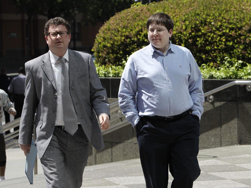 FILE -- In this April 23, 2013 file photo, Matthew Keys, right, who faces federal charges that he allegedly conspired with the hacking group Anonymous to break into the Los Angeles Times,' website, walks to the federal courthouse for his arraignment with his attorney Jason Leiderman, in Sacramento, Calif. Keys was convicted Wednesday, Oct. 7, 2015 of giving Anonymous the log-in credentials to the computer system of the Tribune Co., which owns the Los Angeles Times, Chicago Tribune, Baltimore Sun and other media properties. (AP Photo/Rich Pedroncelli,file)