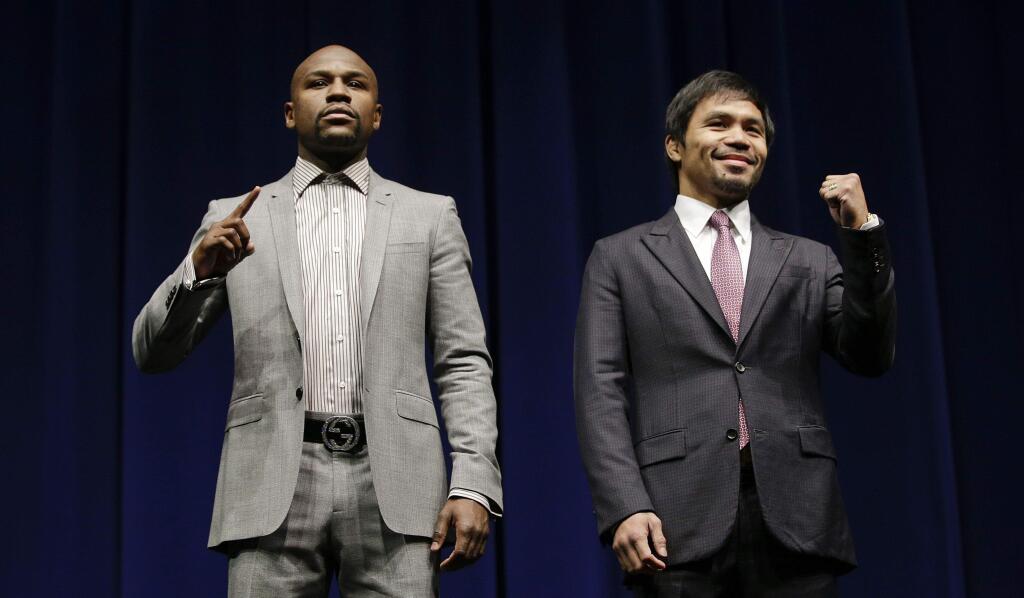 Floyd Mayweather Jr., left, and Manny Pacquiao will fight in Las Vegas on May 2. (Jae C. Hong / Associated Press)
