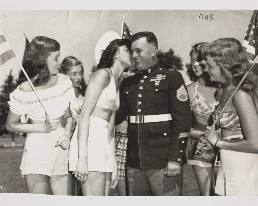 Marine gets a kiss from Sonoma County 'Fairettes' at the Sonoma County Fair, Santa Rosa, California, 1948. Left to right: Margaret Pola; Phyllis Fowlie; Dolores Selby, delivering kiss; Joan Stolting, behind Marine; unidentified Marine; Sheila Hughes; Joan Metcalf. (Courtesy of the Sonoma County Fair and Sonoma County Library)