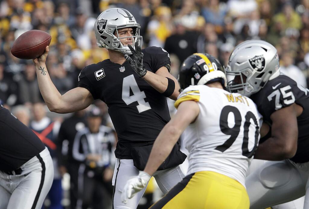 In this Sunday, Dec. 9, 2018, file photo, Oakland Raiders quarterback Derek Carr passes against the Pittsburgh Steelers during the first half in Oakland. (AP Photo/Jeff Chiu, FIle)