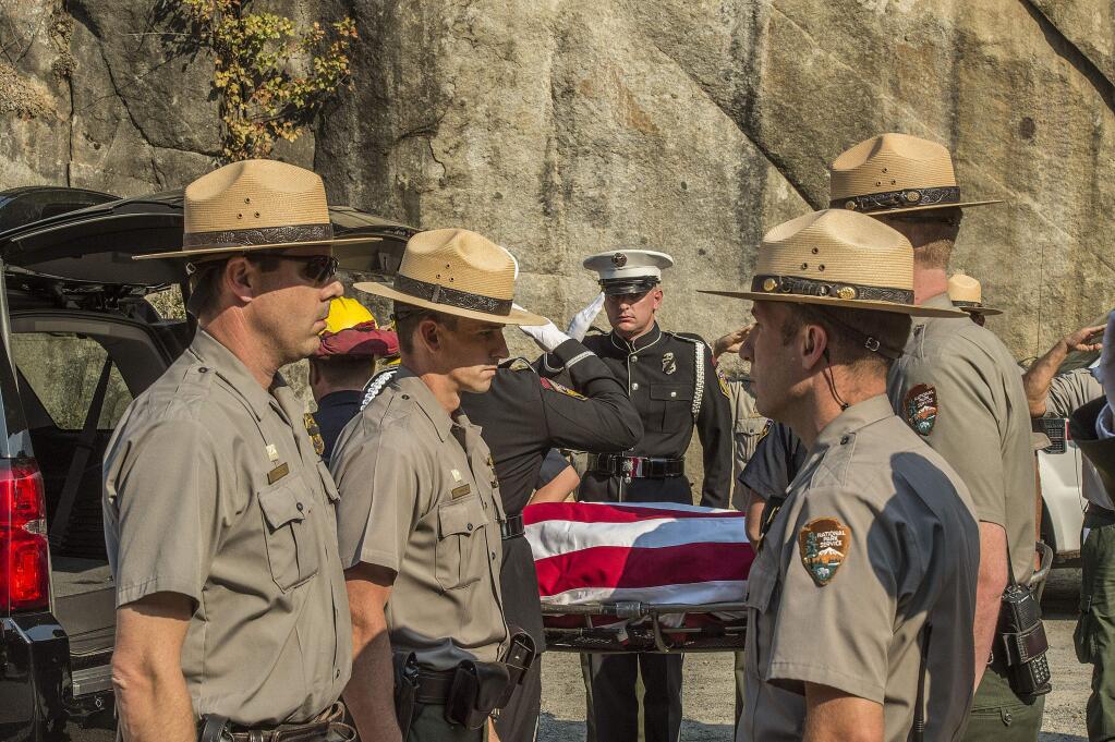 Yosemite National Park Rangers transfer the body of a Cal Fire pilot who was killed in an airplane crash in Yosemite National Park, Calif., on Wednesday, Oct. 8, 2014. (AP Photo/Al Golub)