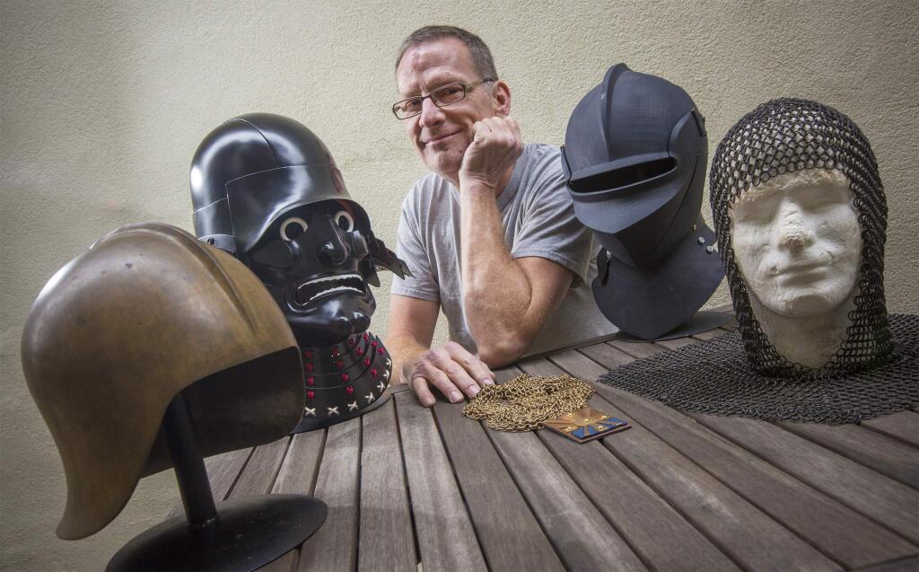 Luke Apker, a Master Armourer, and proprietor of Apker Metalworks, with a selection of his handmade historical helmets. Apker works in metal and has fashioned objects for movies, tv, private collections and more. (Photo by Robbi Pengelly/Index-Tribune)