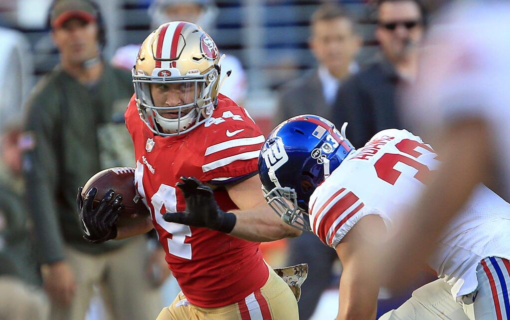 Kyle Juszczyk gains yardage in the fourth quarter during San Francisco's 31-21 win over the Giants in Santa Clara, Sunday Nov. 12, 2017. (Kent Porter / The Press Democrat)