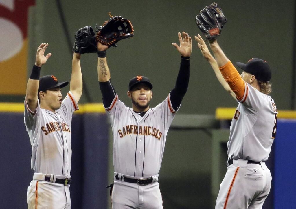 San Francisco Giants' Nori Aoki, left to right, Gregor Blanco and Hunter Pence celebrate after a baseball game against the Milwaukee Brewers Tuesday, May 26, 2015, in Milwaukee. The Giants won 6-3. (AP Photo/Morry Gash)