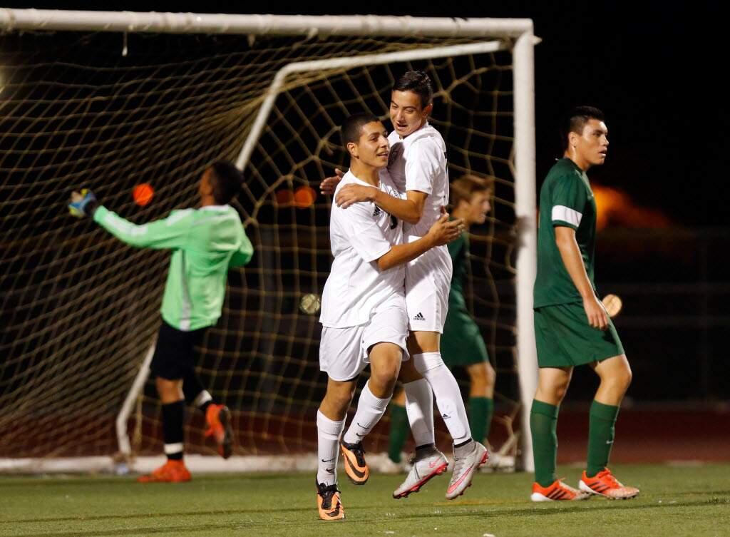 Elsie Allen's Jesus Torres, right, congratulates teammate Jose Cervantes (16) on his goal while Sonoma Valley goalkeeper Victor Fernandez, left, jumps up in frustration, during the first half of their match on Oct. 14. (Alvin Jornada / The Press Democrat)