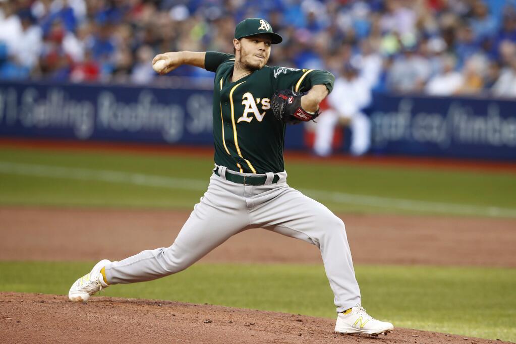 Oakland Athletics starting pitcher Sonny Gray throws to a Toronto Blue Jays batter during the first inning of a baseball game Tuesday, July 25, 2017, in Toronto. (Mark Blinch/The Canadian Press via AP)