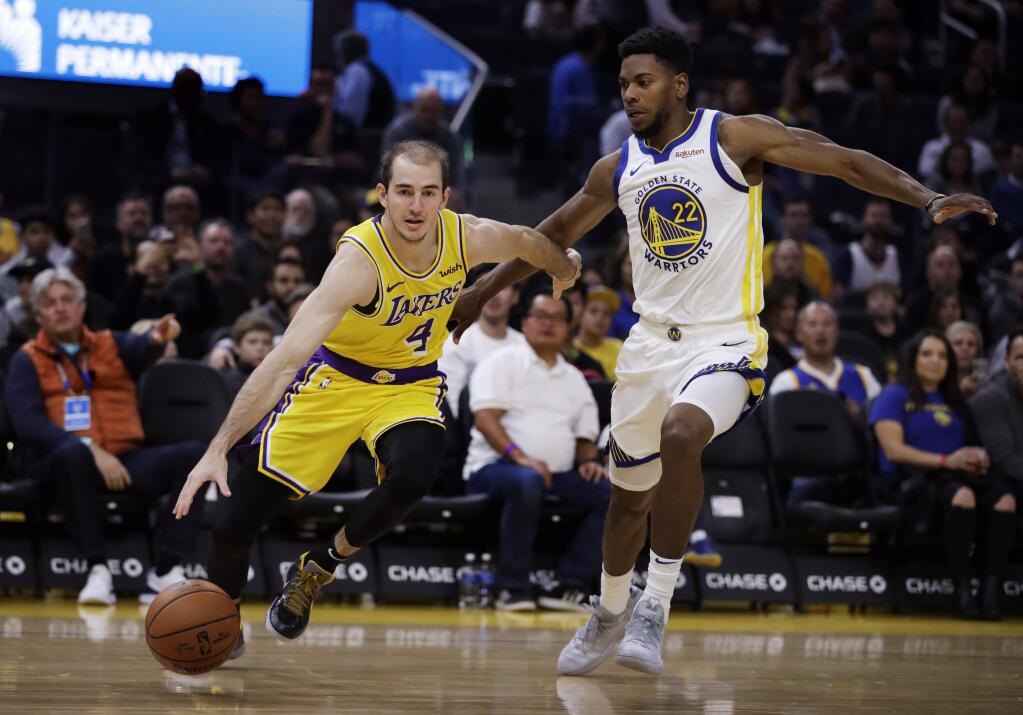 The Los Angeles Lakers' Alex Caruso, left, drives the ball past the Golden State Warriors' Glenn Robinson III during the first half of a preseason game Friday, Oct. 18, 2019, in San Francisco. (AP Photo/Ben Margot)