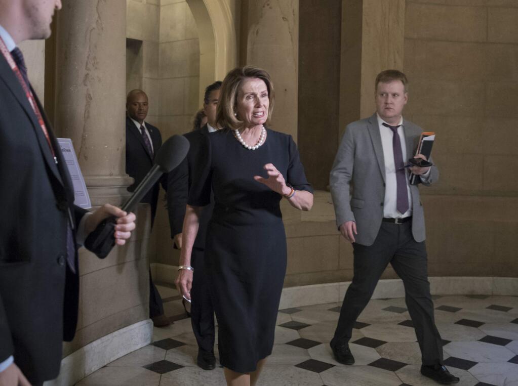 In this photo taken Wednesday evening Sept. 13, 2017, House Minority Leader Nancy Pelosi, D-Calif., leaves the office of House Speaker Paul Ryan on her way to meet with President Donald Trump to discuss a legislative solution for the Deferred Action for Childhood Arrivals program, at the Capitol in Washington. Trump denied Thursday morning an assertion by Pelosi and Senate Minority Leader Chuck Schumer, D-N.Y., that they reached an agreement with him that would preserve protections for young immigrants in the U.S. illegally. (AP Photo/J. Scott Applewhite)