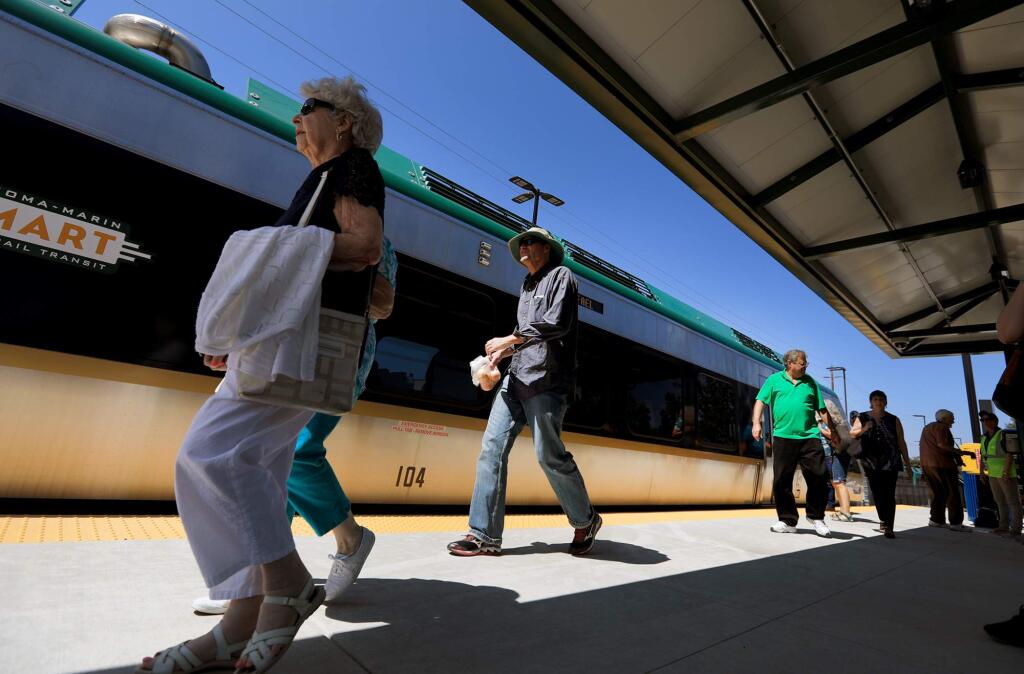 Passengers use the Airport Blvd. SMART platform to catch the first regular scheduled train, Friday August 25, 2017 in Santa Rosa. (Kent Porter / The Press Democrat) 2017