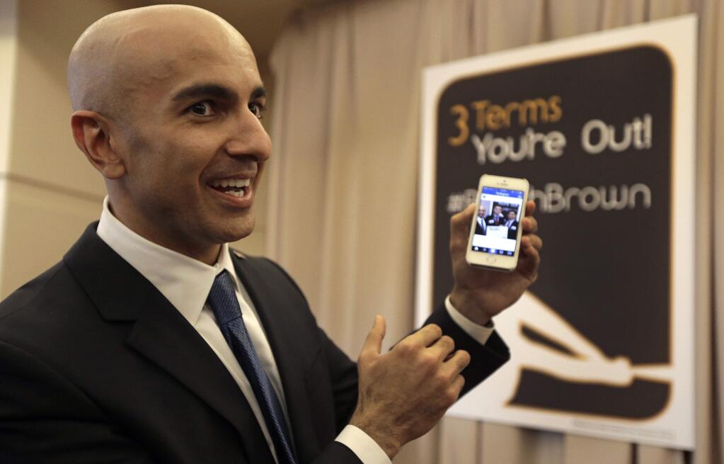 FILE -- In this March 14, 2014 file photo, Gubernatorial candidate Neel Kashkari displays a campaign video posted to Instagram at the California Republican Party 2014 Spring Convention in Burlingame, Calif. Kashkari, a former U.S. Treasury official who has never held elective office, is challenging incumbent Gov. Jerry Brown in the November election.(AP Photo/Ben Margot, file)