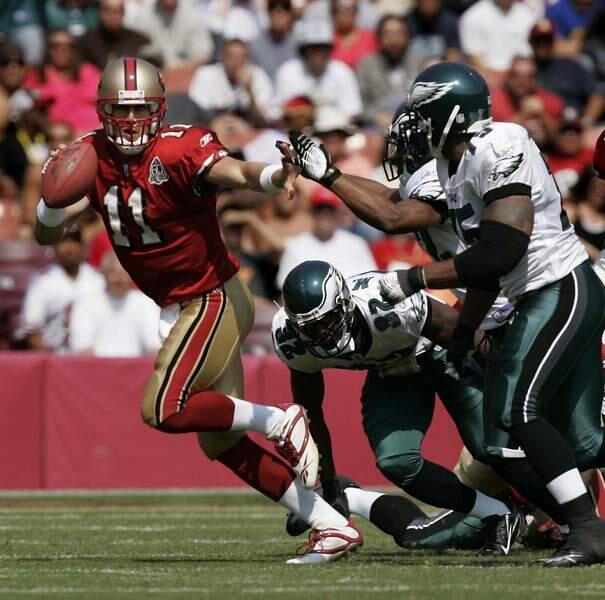San Francisco 49ers quarterback Alex Smith is flushed out of the pocket as he goes hand to hand with the Philadelphia Eagles defense to throw an incomplete pass in the second quarter of their game Sunday September 24, 2006. Eagles won 38-24. (Press Democrat / Chad Surmick)