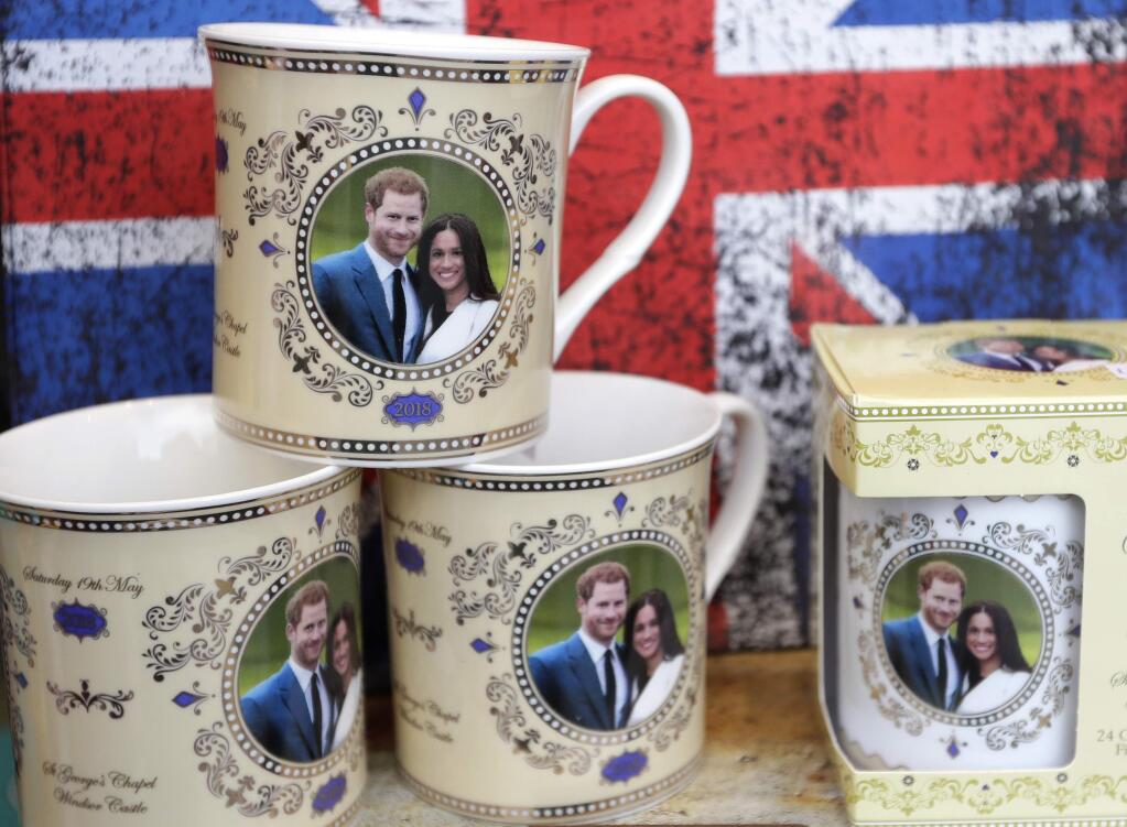 Mugs with the image of Britain's Prince Harry and Meghan Markle are seen displayed for sale in a shop window in Windsor, England, Thursday, March 29, 2018. Britain's Prince Harry will marry Meghan Markle in Windsor on May 19. (AP Photo/Kirsty Wigglesworth)